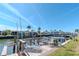 Private boat dock with seating, offering direct access to the canal and serene waterfront views under a clear sky at 18675 Us Highway 19 N # 217, Clearwater, FL 33764