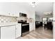 Bright kitchen featuring modern appliances, sleek countertops, and wood-look flooring, adjacent to the dining area at 18675 Us Highway 19 N # 217, Clearwater, FL 33764