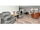 Comfortable living room with two recliner chairs and wood-look flooring at 18675 Us Highway 19 N # 217, Clearwater, FL 33764