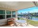 Cozy covered patio with outdoor seating, overlooking a picturesque waterfront canal and neighboring houses at 18675 Us Highway 19 N # 217, Clearwater, FL 33764