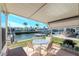 Covered patio with dining set and grill, overlooking scenic canal, perfect for outdoor entertaining and waterfront living at 18675 Us Highway 19 N # 217, Clearwater, FL 33764