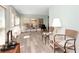 Bright sunroom with laminate flooring, large windows, comfortable seating, and beadboard walls provides versatile living space at 18675 Us Highway 19 N # 217, Clearwater, FL 33764