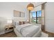 Bedroom with a large window, side tables, and neutral decor at 19410 Indian Rock Pl, Lakewood Ranch, FL 34211