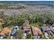 A neighborhood aerial shot showcases the beautiful homes in the community and the lush, wooded surroundings at 2075 Warwick Dr, Oldsmar, FL 34677