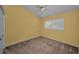 Neutral bedroom features carpet, ceiling fan, and window allowing natural light at 2075 Warwick Dr, Oldsmar, FL 34677