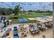 Expansive clubhouse patio with golf course views, comfortable seating, and ample tables with umbrellas at 2075 Warwick Dr, Oldsmar, FL 34677