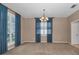 Spacious dining room with neutral carpet, large windows, and an elegant chandelier at 2075 Warwick Dr, Oldsmar, FL 34677