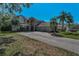 Exterior angle of a well-kept two-story home with mature landscaping and a three-car garage on a sunny day at 2075 Warwick Dr, Oldsmar, FL 34677