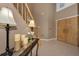Inviting foyer featuring tile floors, a staircase, and a decoratively adorned console table at 2075 Warwick Dr, Oldsmar, FL 34677