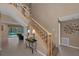 Inviting foyer with a staircase, tile flooring, and a view of the living room and outdoor pool area at 2075 Warwick Dr, Oldsmar, FL 34677