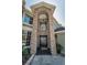 Close up on the stone facade surrounding the arched window and double doors of the front entryway at 2075 Warwick Dr, Oldsmar, FL 34677