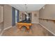 Game room features a billiard table, neutral carpet, shuttered windows, and wainscotting at 2075 Warwick Dr, Oldsmar, FL 34677