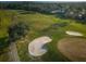 Aerial view of a lush golf course featuring sand traps, manicured greens and residential homes at 2075 Warwick Dr, Oldsmar, FL 34677
