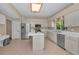 The kitchen features white cabinets, an island, stainless appliances, and tiled floors at 2075 Warwick Dr, Oldsmar, FL 34677