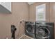 Functional laundry room equipped with a modern washer and dryer and ample space at 2075 Warwick Dr, Oldsmar, FL 34677