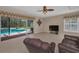 Spacious living room with tile floors, sliding glass doors to the pool area and a comfortable seating arrangement at 2075 Warwick Dr, Oldsmar, FL 34677