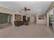 Open living room with tile flooring, comfortable seating, and access to the kitchen and screened-in outdoor area at 2075 Warwick Dr, Oldsmar, FL 34677