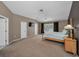 Spacious main bedroom featuring vaulted ceilings, carpeted floor, a fan, and a TV at 2075 Warwick Dr, Oldsmar, FL 34677