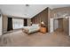 Spacious main bedroom featuring vaulted ceilings, carpeted floor, a fan, and a king size bed with wooden bedframe at 2075 Warwick Dr, Oldsmar, FL 34677