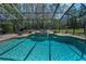Relaxing screened pool and spa with mature landscape views for a peaceful and private backyard experience at 2075 Warwick Dr, Oldsmar, FL 34677