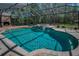 Screened pool with brick patio, stone fireplace, and integrated spa offers outdoor enjoyment year-round at 2075 Warwick Dr, Oldsmar, FL 34677