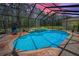Sparkling screened pool and spa combo with brick patio, water features, and a peaceful private backyard at 2075 Warwick Dr, Oldsmar, FL 34677