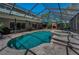 Screened pool area with a stone fireplace, a spa and outdoor seating offers year-round entertainment at 2075 Warwick Dr, Oldsmar, FL 34677