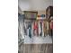 Well-organized walk-in closet with ample hanging space and shelving for clothes and shoes at 2075 Warwick Dr, Oldsmar, FL 34677