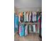 Well-organized walk-in closet with ample hanging space and shelving for clothes and shoes at 2075 Warwick Dr, Oldsmar, FL 34677