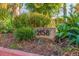 Close-up of the house number (2158) displayed on a natural stone amidst lush landscaping at 2158 Blossom S Way, St Petersburg, FL 33712