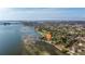 Waterfront property nestled among lush trees with city views in the distance at 2158 Blossom S Way, St Petersburg, FL 33712