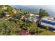 An impressive aerial view of a home featuring lush landscaping and waterfront access at 2158 Blossom S Way, St Petersburg, FL 33712