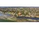 Panoramic aerial view of waterfront neighborhood with lush mature trees at 2158 Blossom S Way, St Petersburg, FL 33712