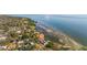 Panoramic aerial view of a waterfront home surrounded by mature trees on a sunny day at 2158 Blossom S Way, St Petersburg, FL 33712