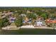 An aerial view showcasing a waterfront home with lush tropical surroundings at 2158 Blossom S Way, St Petersburg, FL 33712