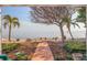 Picturesque backyard with a brick path leading to a tranquil waterfront view at 2158 Blossom S Way, St Petersburg, FL 33712