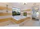 Bright primary bathroom features a garden tub, a large window, and a walk-in shower at 2158 Blossom S Way, St Petersburg, FL 33712