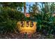 Illuminated house number displayed on a stone amidst lush landscaping, enhancing curb appeal at 2158 Blossom S Way, St Petersburg, FL 33712