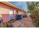 Exterior view of home with brick walkway, colorful trim, and tropical plants at 2158 Blossom S Way, St Petersburg, FL 33712