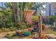 Lush front yard featuring diverse plants, brick pathway, and an electric car charging station at 2158 Blossom S Way, St Petersburg, FL 33712