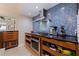 Stylish kitchen featuring modern appliances, wood cabinetry, black countertop and colorful backsplash at 2158 Blossom S Way, St Petersburg, FL 33712