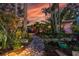 Beautifully landscaped walkway leading to a charming home, surrounded by lush greenery at 2158 Blossom S Way, St Petersburg, FL 33712
