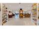 Bright living room with built-in bookshelves and an open floor plan leading to the dining and kitchen areas at 2158 Blossom S Way, St Petersburg, FL 33712