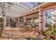 Covered patio with beautiful brick flooring and comfortable seating, perfect for outdoor relaxation at 2158 Blossom S Way, St Petersburg, FL 33712