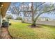 Backyard with a mature tree, greenery, and privacy wall at 2263 Citrus Ct, Clearwater, FL 33763