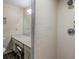 Tiled shower stall with updated fixtures, and a vanity area with black tile flooring at 2263 Citrus Ct, Clearwater, FL 33763