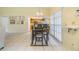 Bright dining room with tile floors, modern light fixture and an open concept to the kitchen at 2263 Citrus Ct, Clearwater, FL 33763