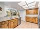 Open kitchen with stainless steel dishwasher, granite countertops, and wood cabinets at 2263 Citrus Ct, Clearwater, FL 33763