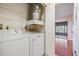 Laundry room with a washer, dryer, and an adjacent outdoor patio at 2263 Citrus Ct, Clearwater, FL 33763