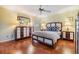 Cozy main bedroom featuring laminate floors, neutral walls, ceiling fan, and closet at 2263 Citrus Ct, Clearwater, FL 33763